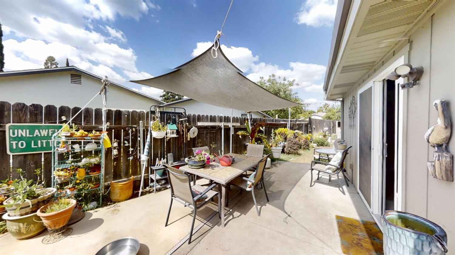 2956 Treen Court Rancho Cordova, CA 95670 - Photo 42 of 67 a view of a patio with table and chairs potted plants and a large tree