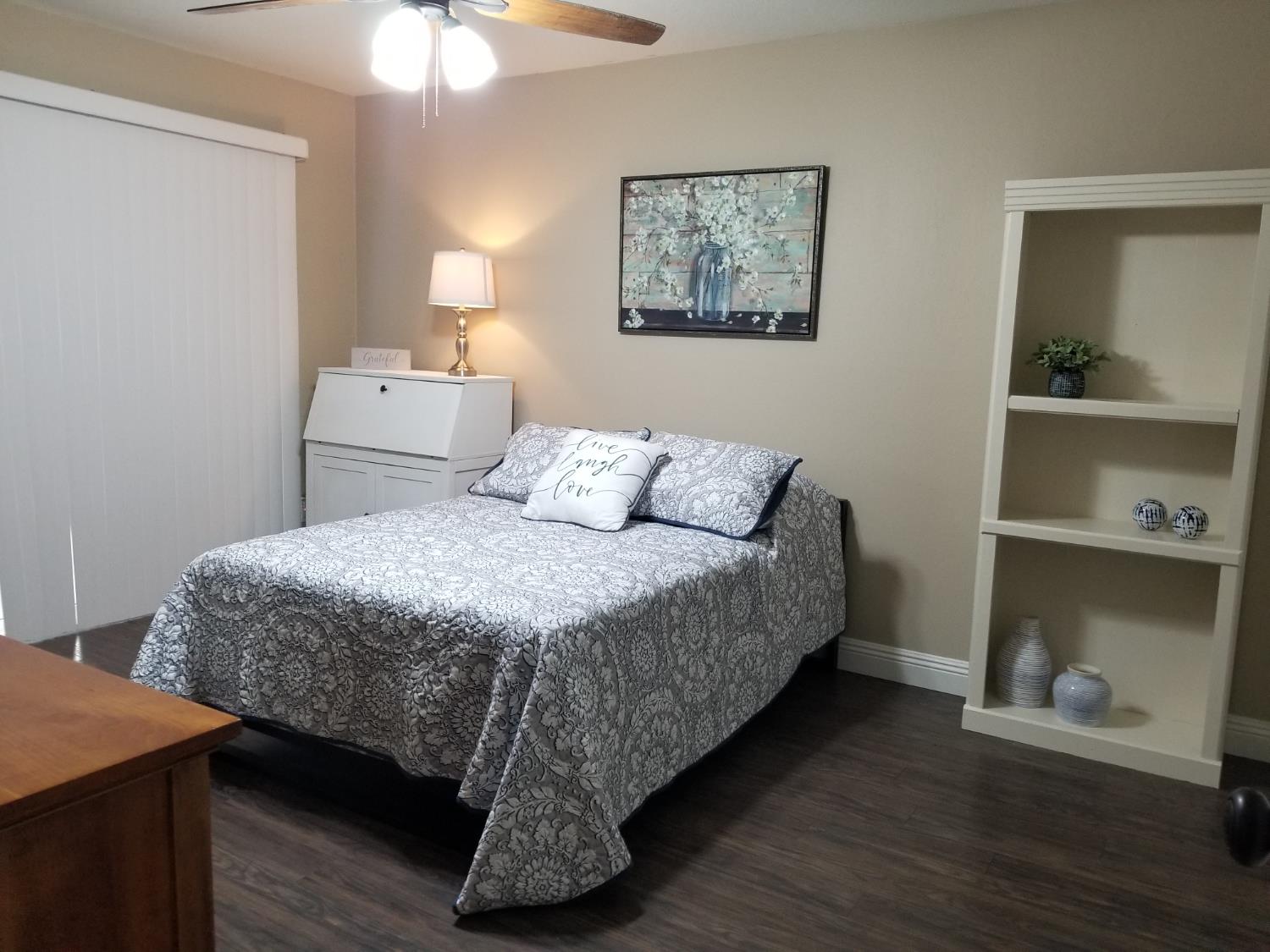 2956 Treen Court Rancho Cordova, CA 95670 - Photo 64 of 67 a bedroom with a bed and a lamp on dresser