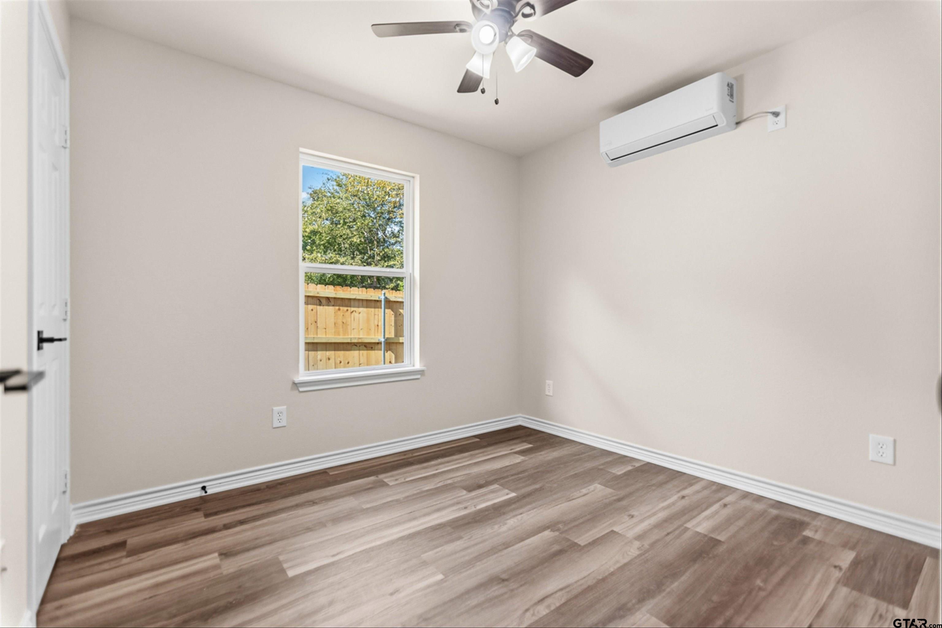 22463 Trailwood Road Flint, TX 75762 - Photo 7 of 17 wooden floor in an empty room with a window