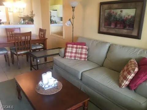 a living room with furniture flowerpot and a window
