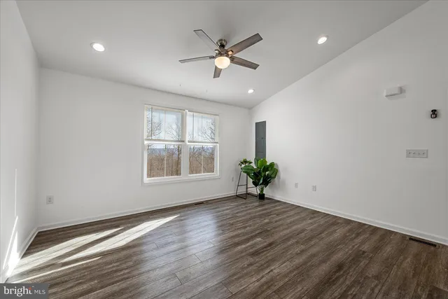 a kitchen with a refrigerator and a stove top oven