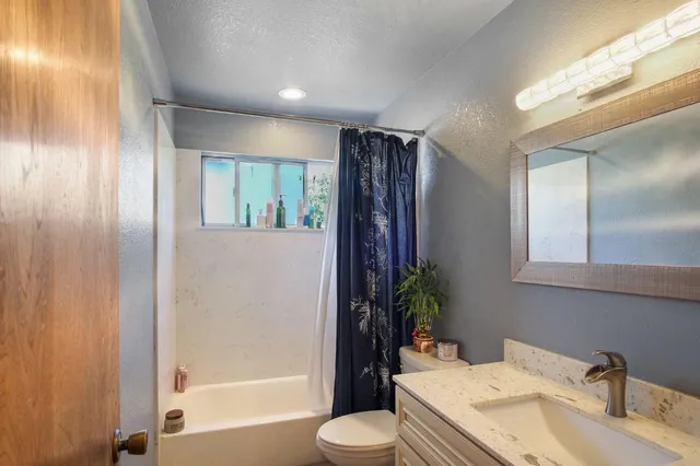 a bathroom with a sink vanity and mirror