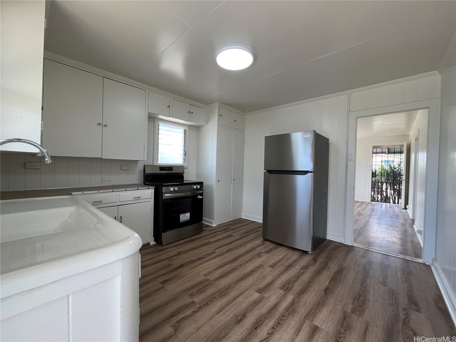91-325 Ewa Beach Road Ewa Beach, HI 96706 - Photo 1 of 1 a kitchen with a refrigerator and a sink