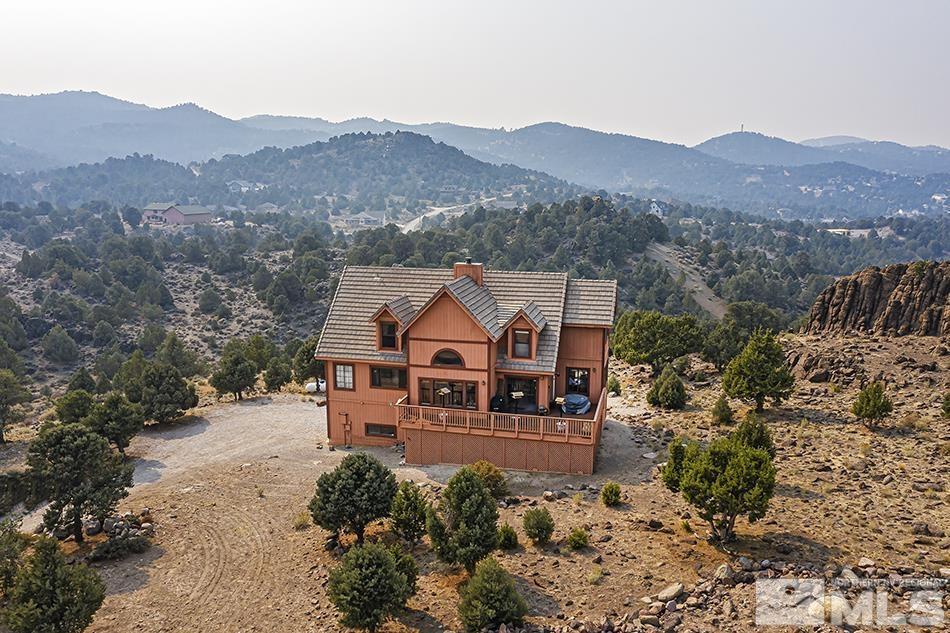 an aerial view of a house with a mountain view