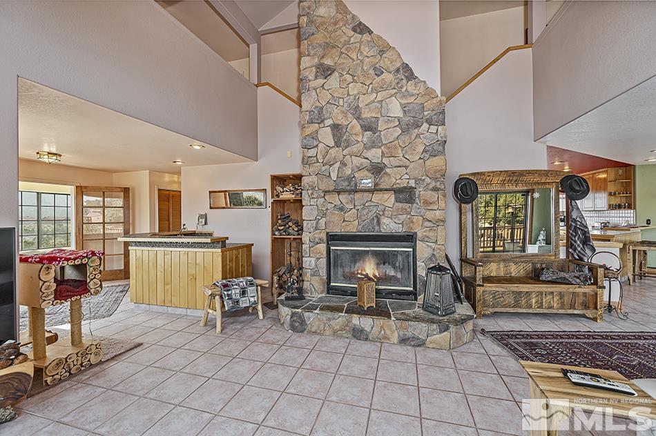 4090 Whiskey Flat Road Reno, NV 89521 - Photo 12 of 29 a living room with furniture a fireplace and next to a window