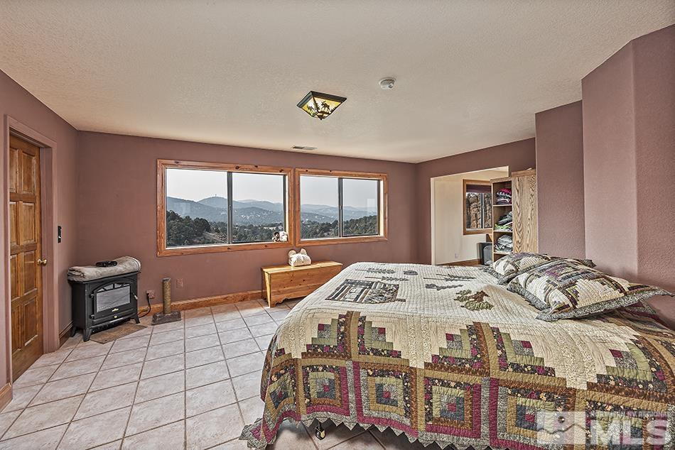 4090 Whiskey Flat Road Reno, NV 89521 - Photo 14 of 29 a bed sitting in a bedroom next to a window