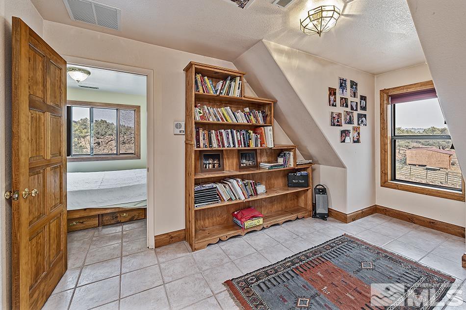 4090 Whiskey Flat Road Reno, NV 89521 - Photo 17 of 29 a room with window and book shelf