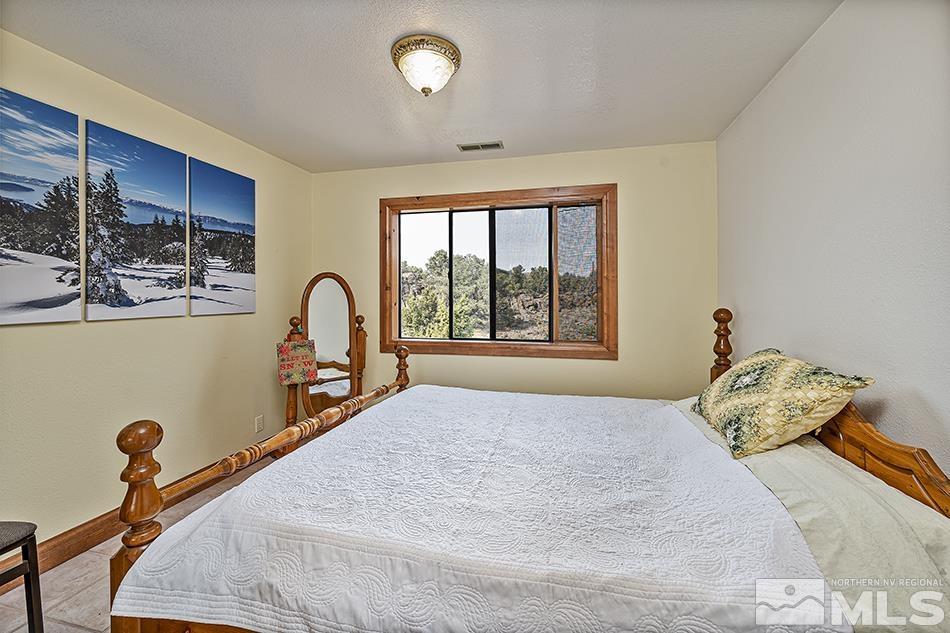 4090 Whiskey Flat Road Reno, NV 89521 - Photo 18 of 29 a bedroom with a bed and a window