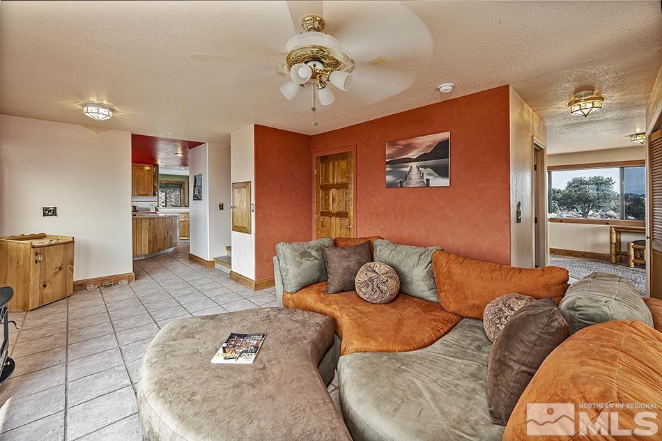 4090 Whiskey Flat Road Reno, NV 89521 - Photo 5 of 29 a living room with furniture and a chandelier