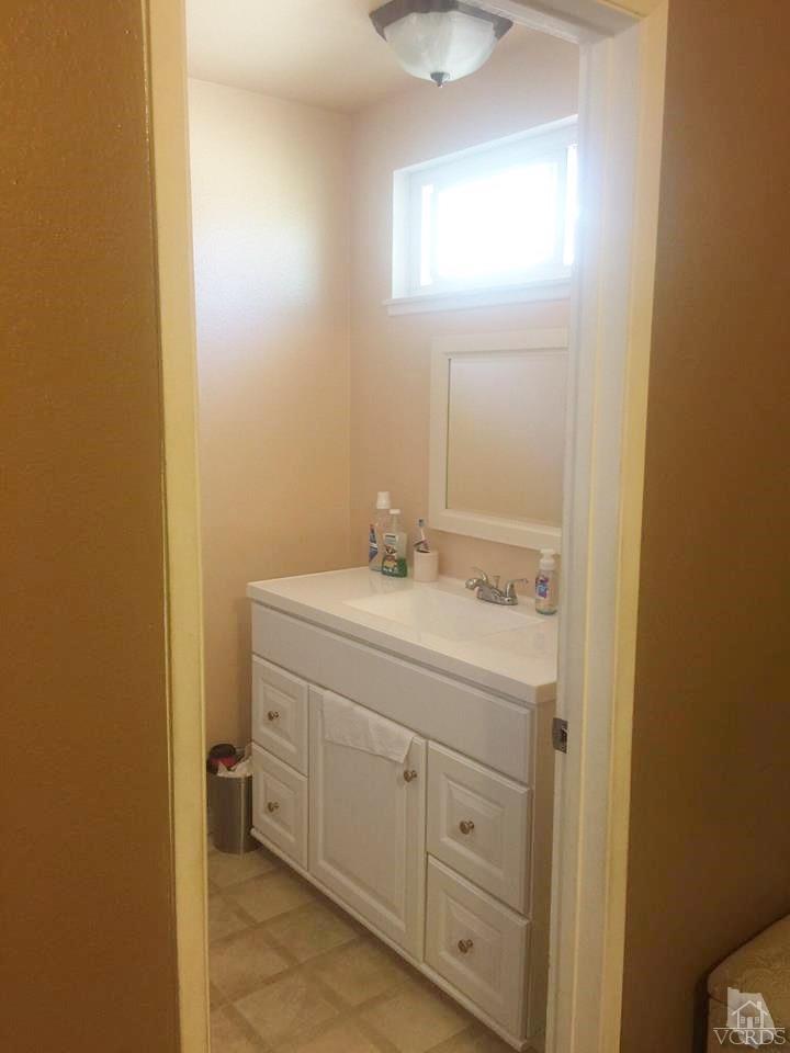 4230 Reeder Avenue Oxnard, CA 93033 - Photo 12 of 12 a bathroom with a sink and a mirror