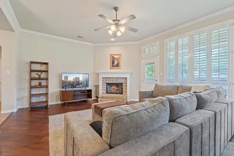 a living room with furniture a large window and a flat screen tv