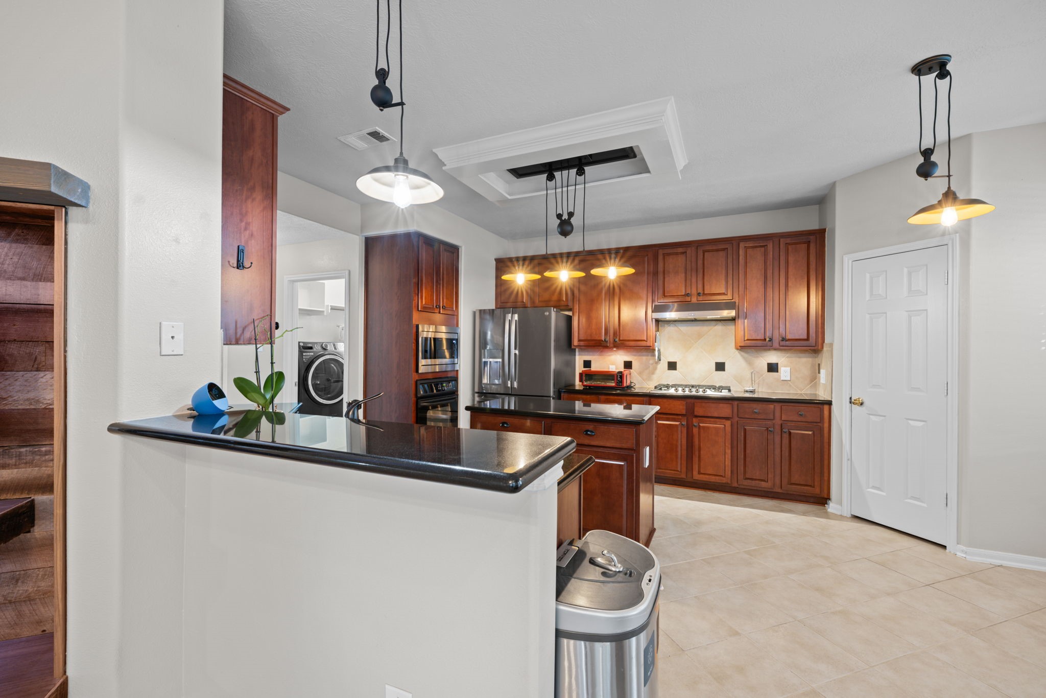 19114 Emory Trail Spring, TX 77388 - Photo 13 of 44 a kitchen with stainless steel appliances kitchen island granite countertop a sink refrigerator and cabinets