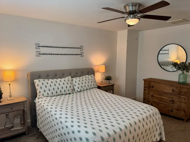 a bedroom with a bed and a chandelier