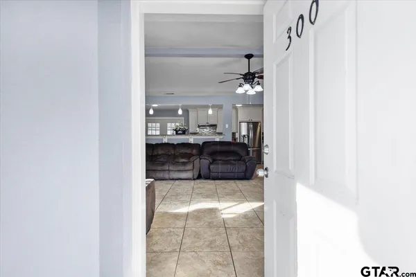 a large bathroom with a glass shower door and a mirror