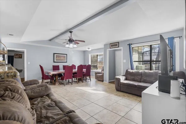 a living room with furniture and a chandelier