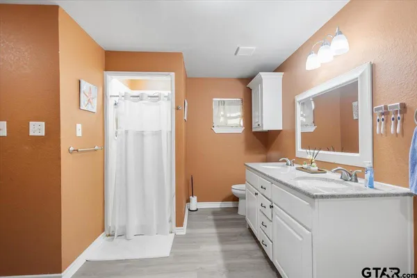 a bathroom with a double vanity sink and mirror