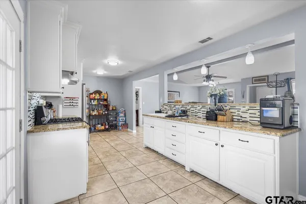 a kitchen with granite countertop a sink and cabinets