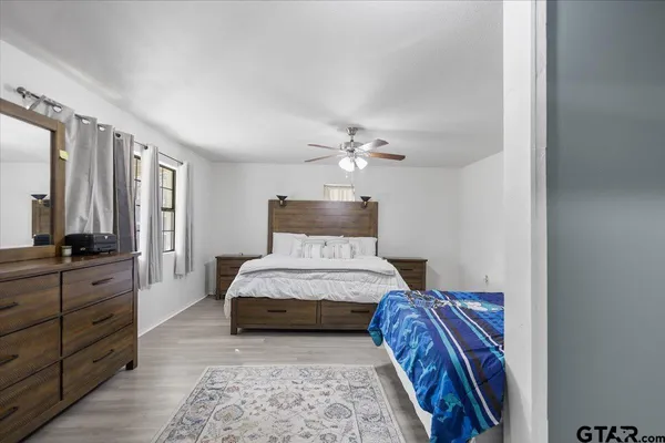 a bedroom with a bed and a chandelier