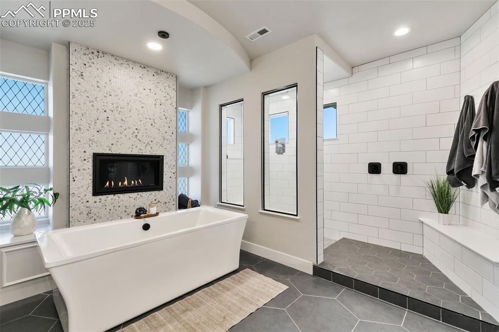 2375 Merlot Drive Colorado Springs, CO 80921 - Photo 4 of 49 a white tub sitting in a room with fireplace and garden