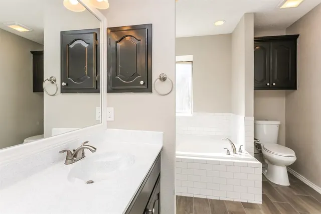 a bathroom with a bathtub sink and toilet