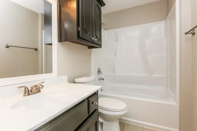 a bathroom with a sink a toilet and bathtub