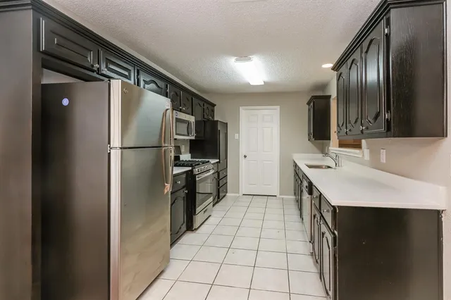 a kitchen with stainless steel appliances a refrigerator and a sink