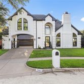 a front view of a house with a yard and a garage