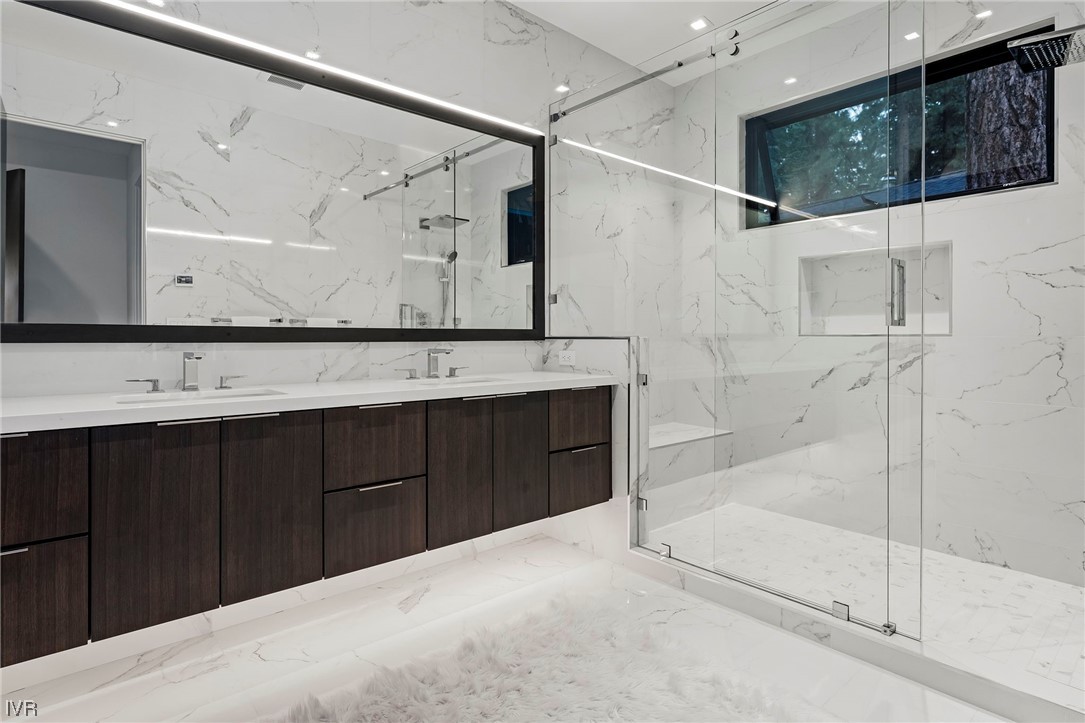 199 Tramway Road Incline Village, NV 89451 - Photo 15 of 49 a bathroom with a double vanity sink a large mirror and shower