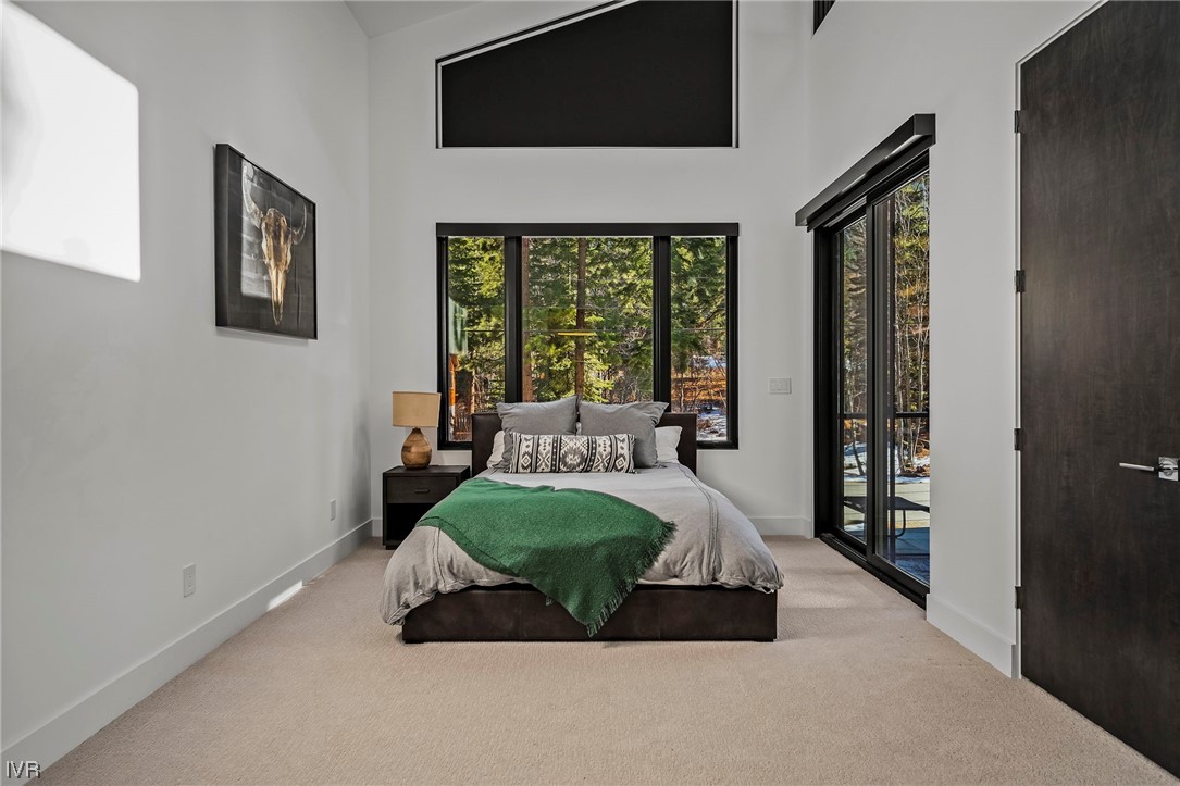 199 Tramway Road Incline Village, NV 89451 - Photo 18 of 49 a spacious bedroom with a bed and glass door