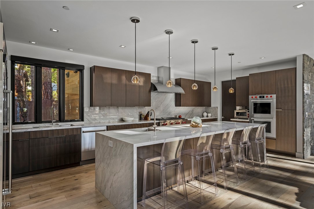 199 Tramway Road Incline Village, NV 89451 - Photo 33 of 49 a kitchen with stainless steel appliances granite countertop a sink a stove and a wooden floor