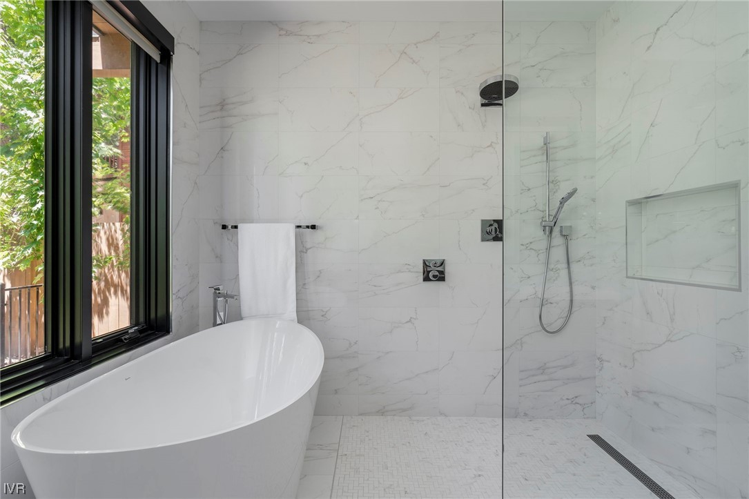 199 Tramway Road Incline Village, NV 89451 - Photo 8 of 49 a bathroom with a white bath tub sitting next to a window