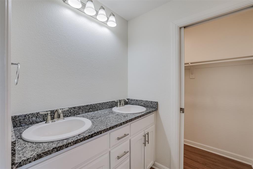 2836 Burchill Road South Fort Worth, TX 76105 - Photo 11 of 18 a bathroom with a granite countertop sink and a mirror
