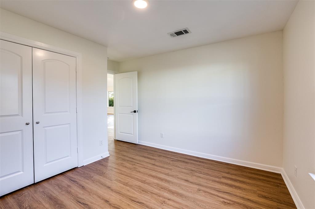 2836 Burchill Road South Fort Worth, TX 76105 - Photo 13 of 18 a view of an empty room with wooden floor