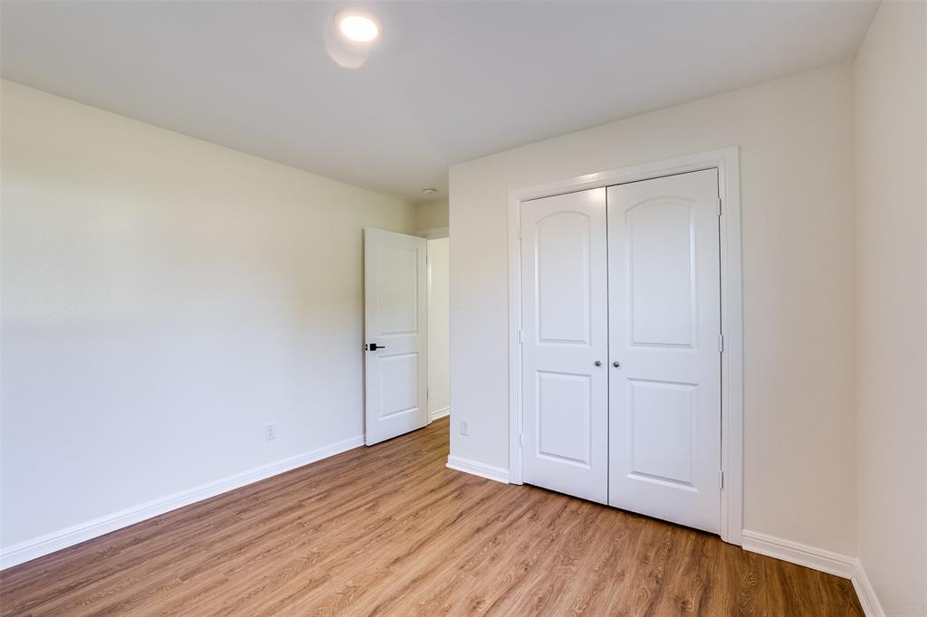 2836 Burchill Road South Fort Worth, TX 76105 - Photo 16 of 18 a view of an empty room and wooden floor