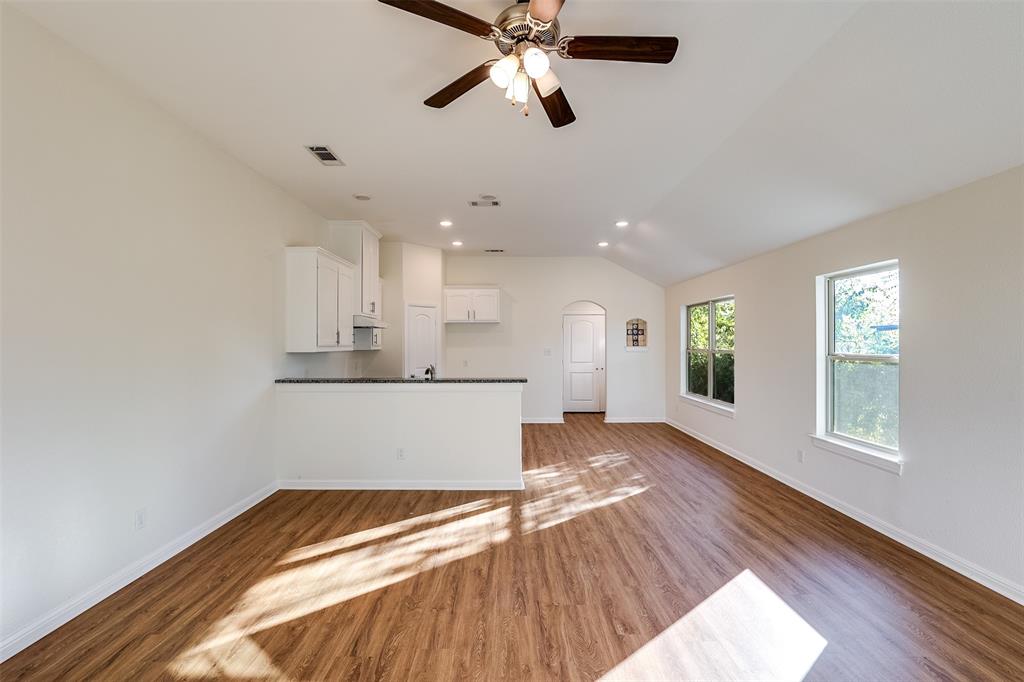 2836 Burchill Road South Fort Worth, TX 76105 - Photo 3 of 18 a view of an empty room with window and wooden floor