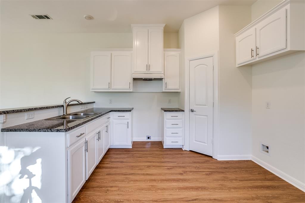 2836 Burchill Road South Fort Worth, TX 76105 - Photo 6 of 18 a kitchen with granite countertop a sink and cabinets