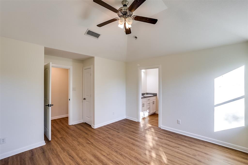 2836 Burchill Road South Fort Worth, TX 76105 - Photo 10 of 18 wooden floor in an empty room with a window