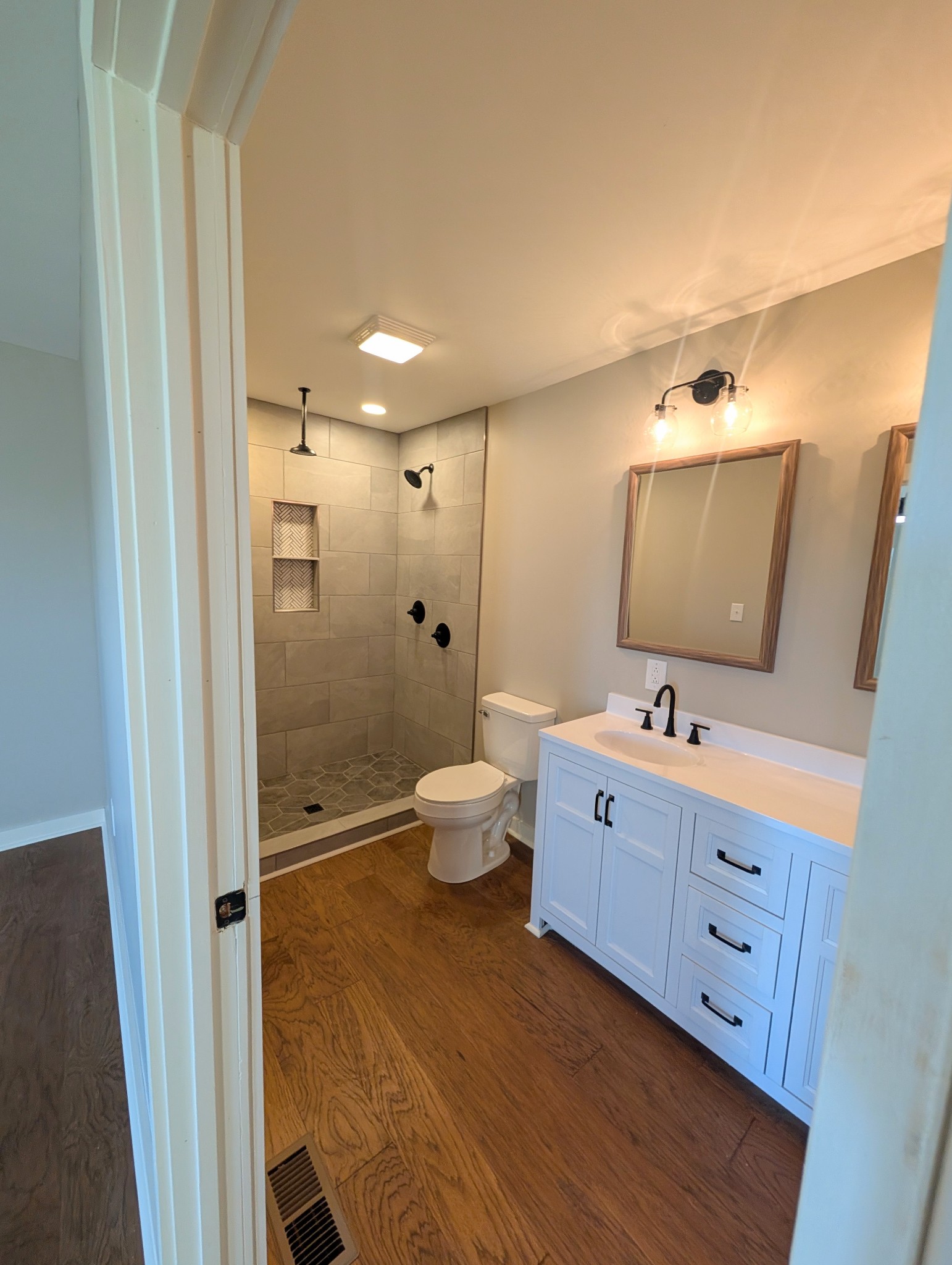 1080 Bybee Branch Road McMinnville, TN 37110 - Photo 16 of 36 a bathroom with a double vanity sink toilet and shower