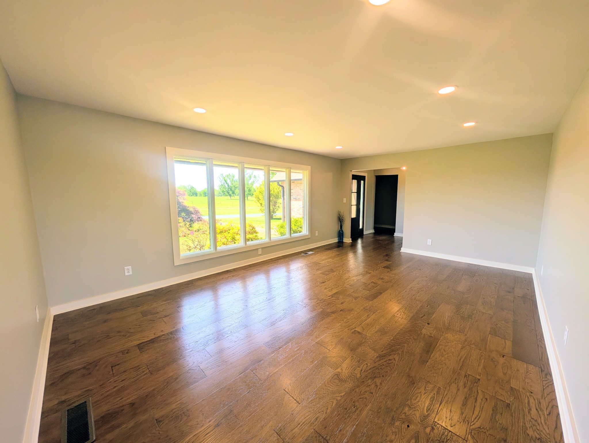 1080 Bybee Branch Road McMinnville, TN 37110 - Photo 6 of 52 a view of an empty room with wooden floor and a window