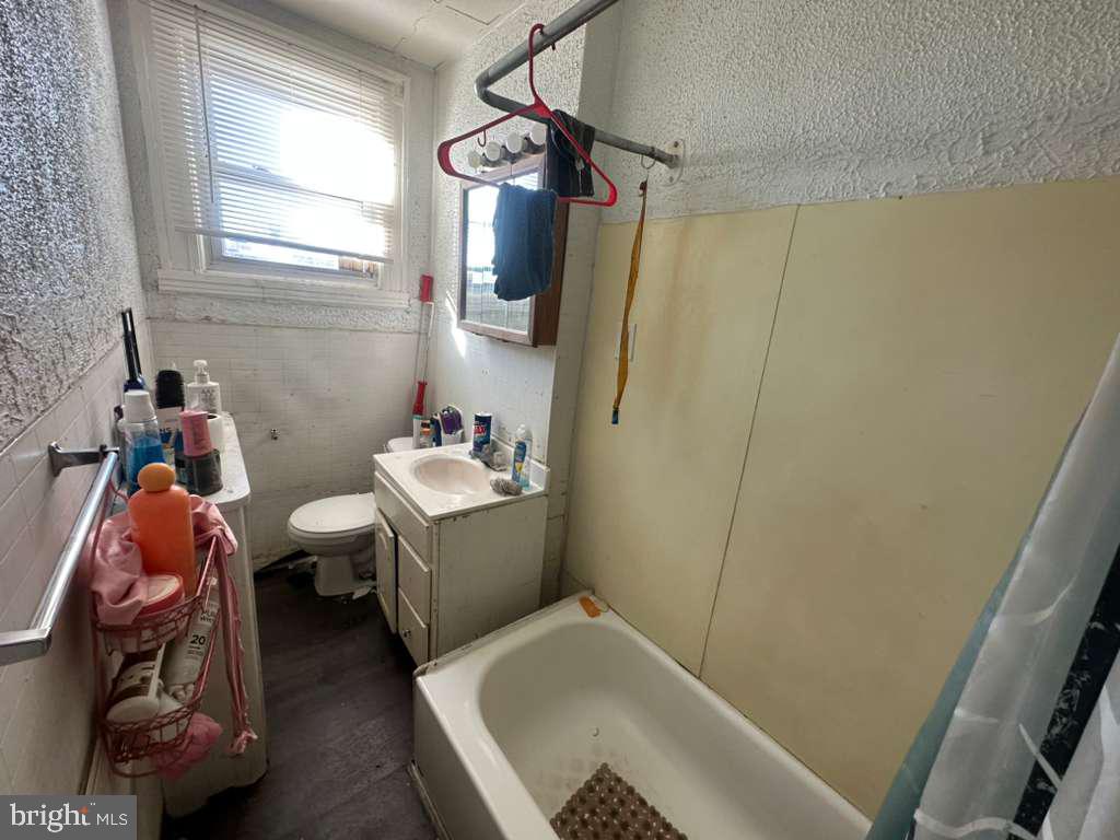 8 North Ellamont Street Baltimore, MD 21229 - Photo 11 of 16 a bathroom with a sink toilet and shower