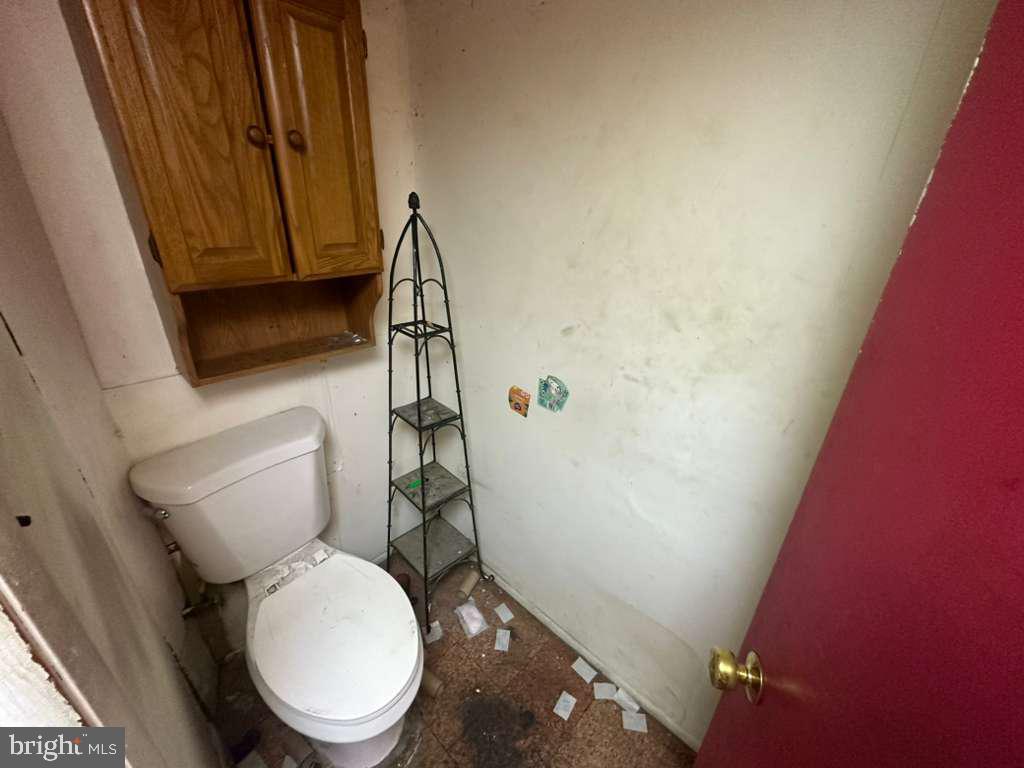 8 North Ellamont Street Baltimore, MD 21229 - Photo 10 of 16 a white toilet sitting next to a shower