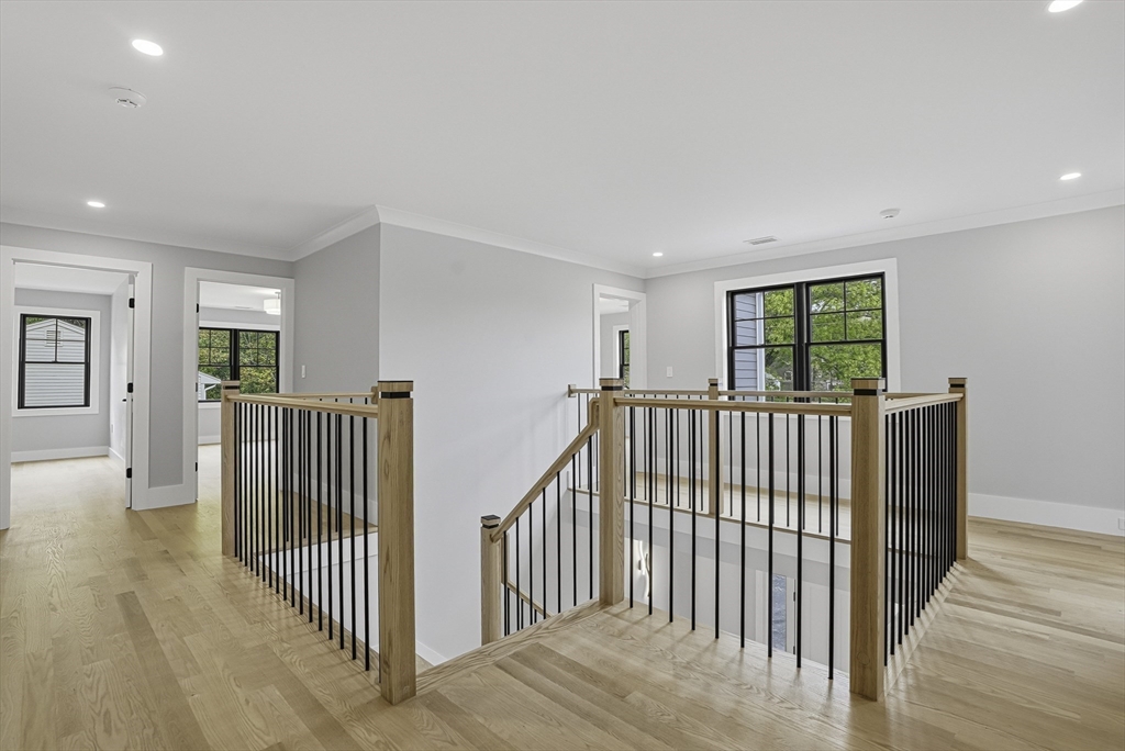 18 Avon Circle Needham, MA 02494 - Photo 11 of 18 a view of a hallway with wooden floor and windows