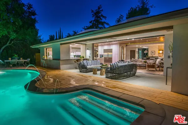 a view of a house with backyard porch and sitting area