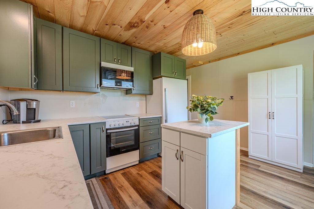 1821 Deerfield Road Boone, NC 28607 - Photo 14 of 33 a kitchen with stainless steel appliances granite countertop a sink stove and refrigerator