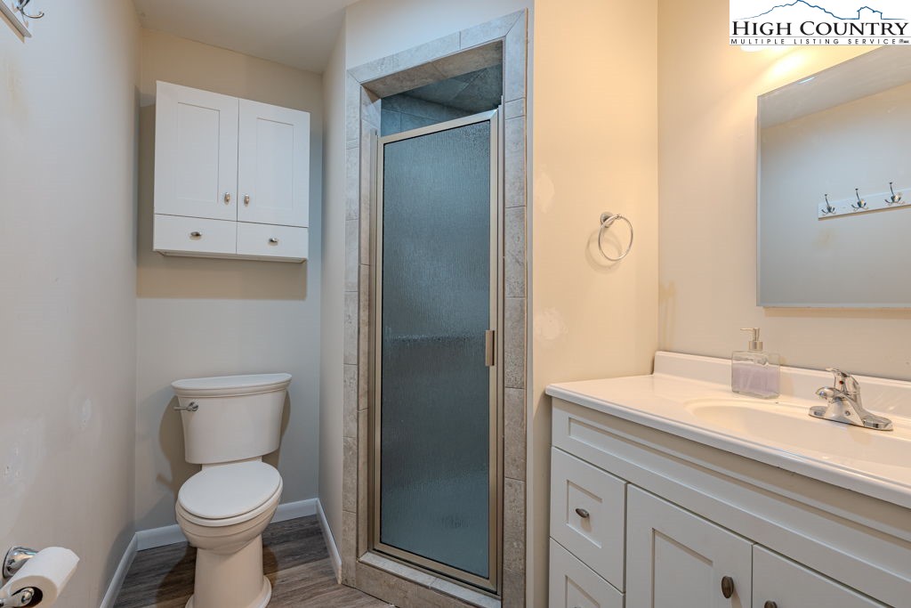 1821 Deerfield Road Boone, NC 28607 - Photo 16 of 33 a bathroom with a toilet sink and mirror