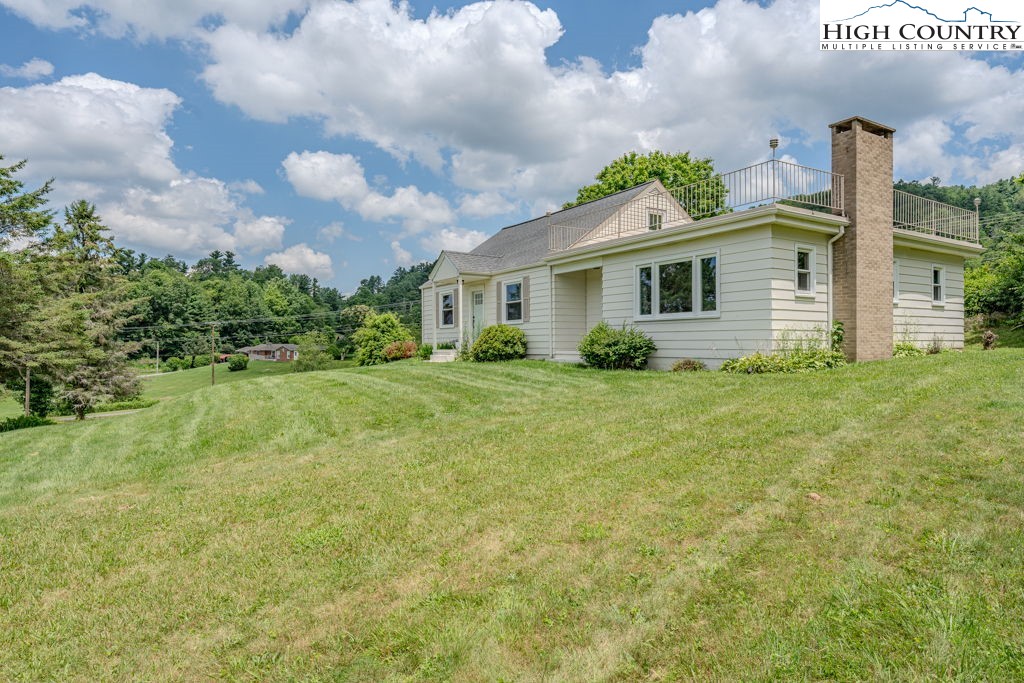 1821 Deerfield Road Boone, NC 28607 - Photo 2 of 33 a house with green field in front of it