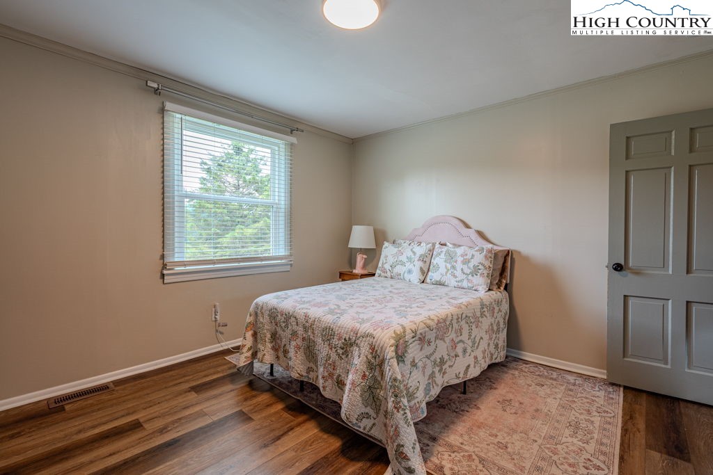 1821 Deerfield Road Boone, NC 28607 - Photo 21 of 33 a bedroom with a bed and window