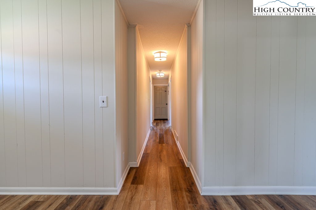 1821 Deerfield Road Boone, NC 28607 - Photo 22 of 33 a view of a hallway with wooden floor and a bathroom