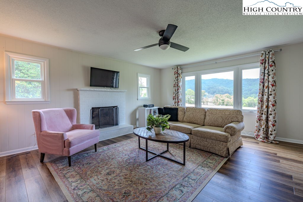1821 Deerfield Road Boone, NC 28607 - Photo 23 of 33 a living room with furniture a flat screen tv and a fireplace