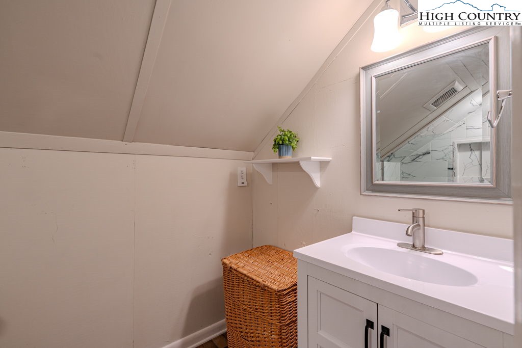 1821 Deerfield Road Boone, NC 28607 - Photo 31 of 33 a bathroom with a sink and a mirror
